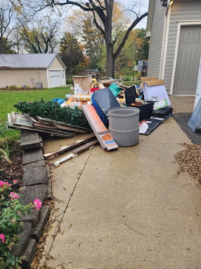 Dumpster being loaded with debris for 10 Yard Dumpster Rental in Yorktown